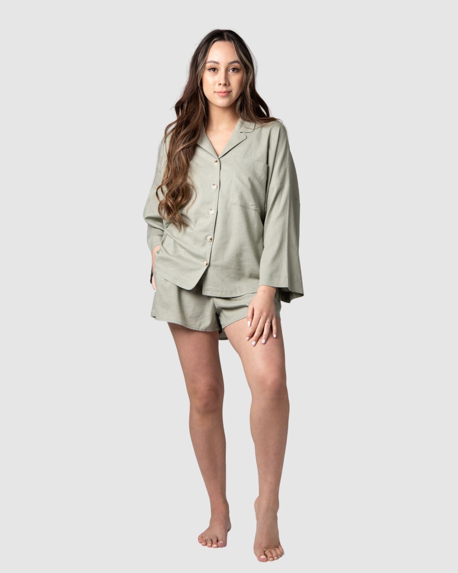 Tatiana, a mama of 1, flaunts the versatility of Hotmilk&#39;s mix-and-match collection. Seamlessly combining the Lounge Top with the Lounge Short, creating the perfect ensemble for warmer days and nights. Both pieces are expertly crafted from a soft linen blend in a serene Sage color, ensuring a comfortable fit with stylish 3/4 length kimono-style sleeves. This set exemplifies the harmonious blend of luxury and comfort, catering to the needs of pregnancy, breastfeeding, and postpartum care